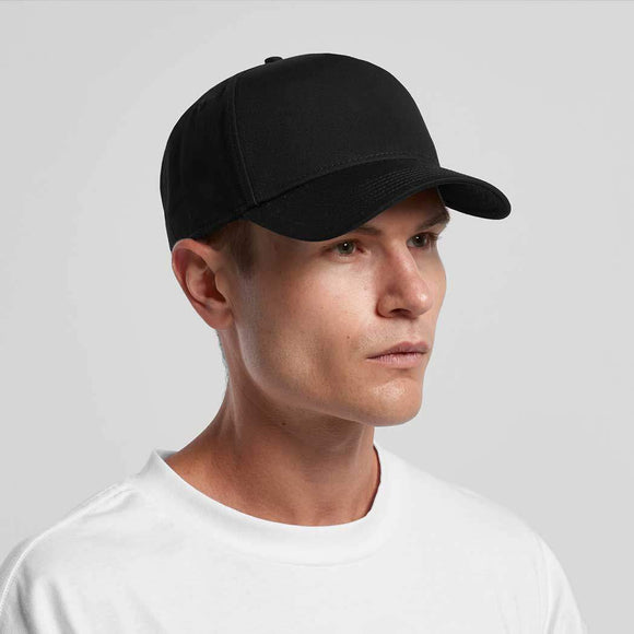 Man wearing a black baseball cap on a light gray background