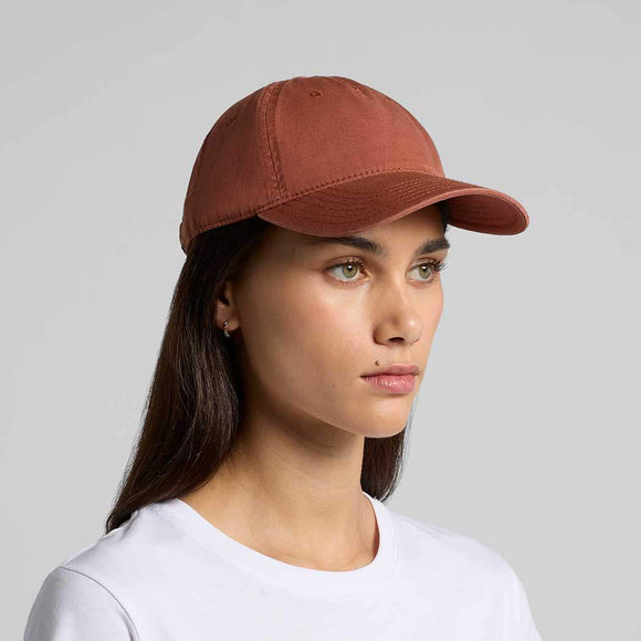 Woman wearing a brown cap against a gray background