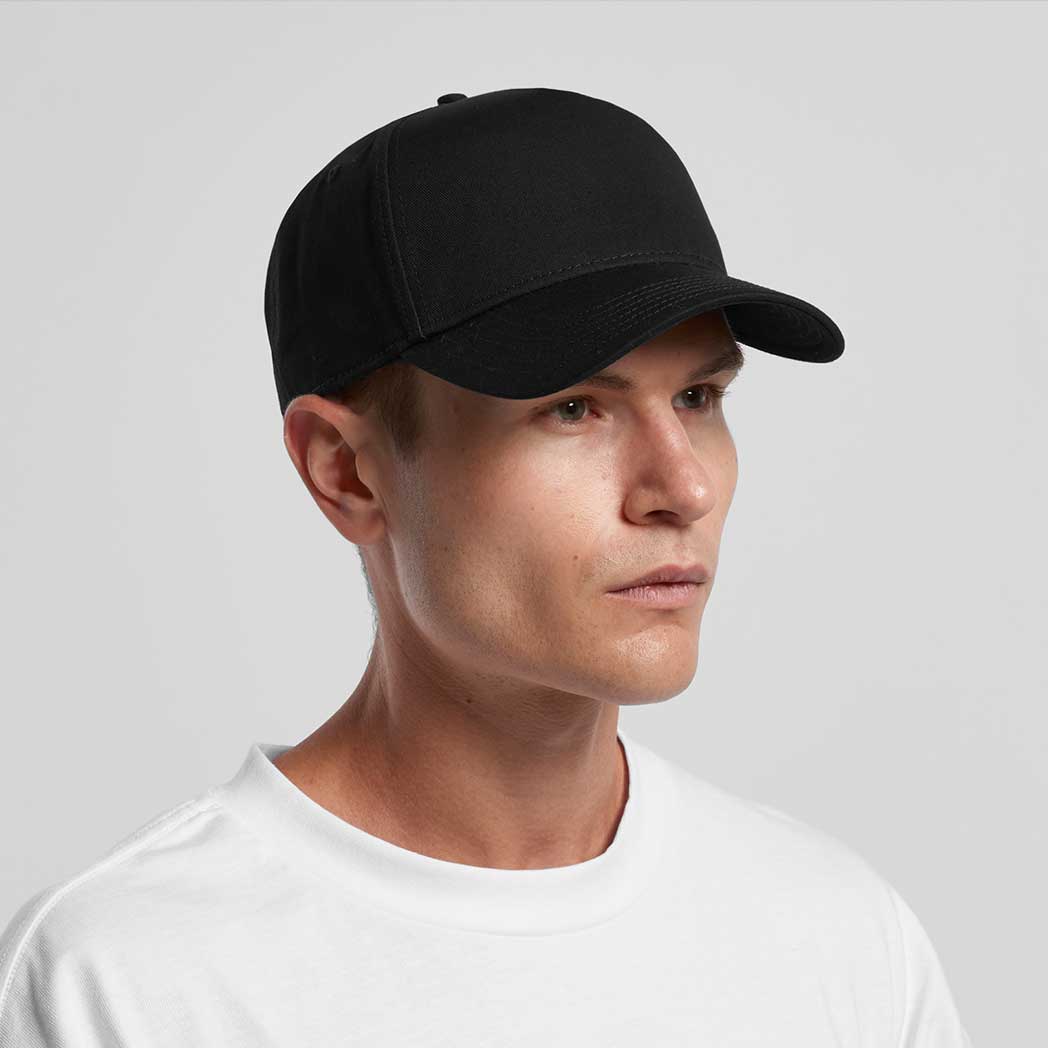 Man wearing a black baseball cap on a light gray background