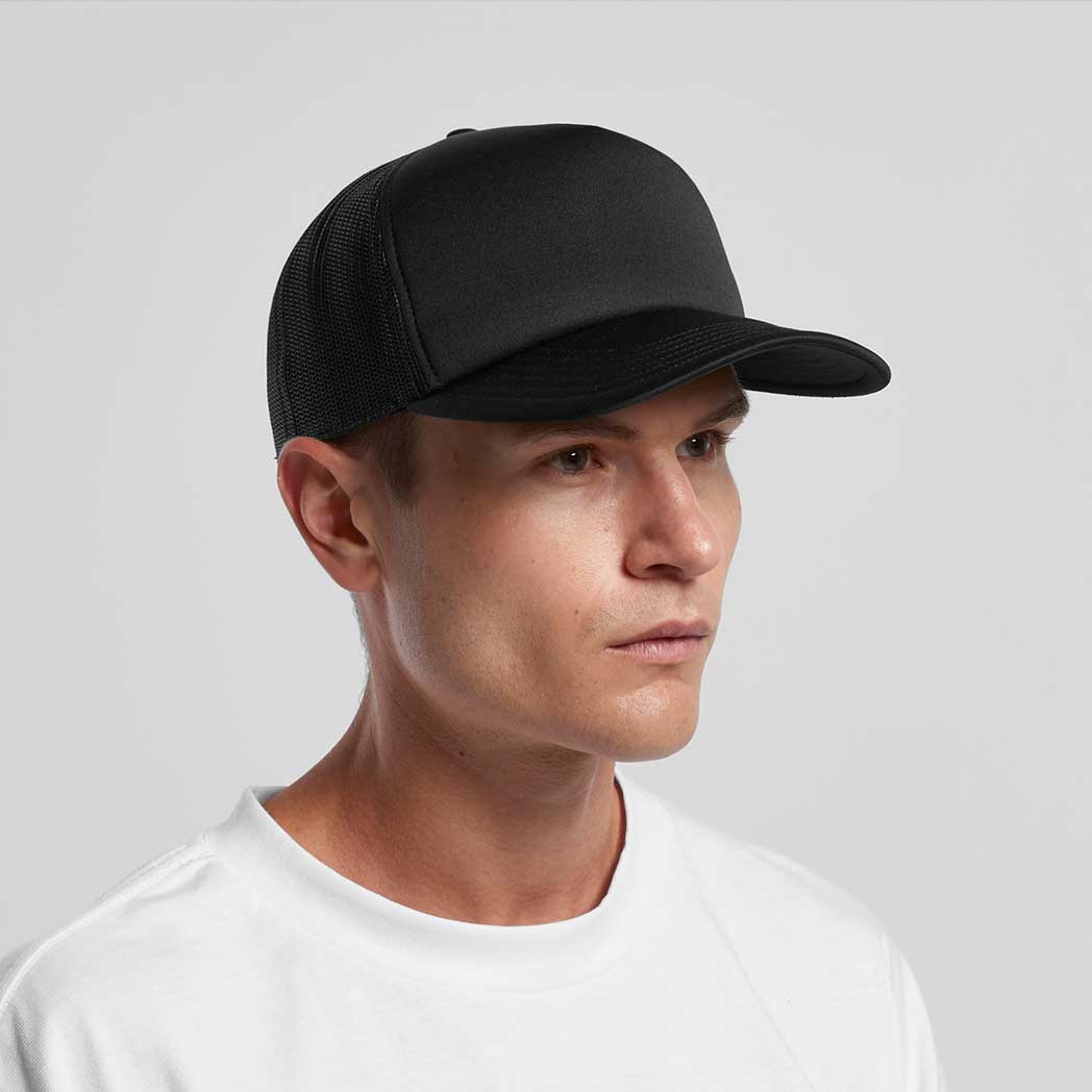 Man wearing a black cap on a gray background