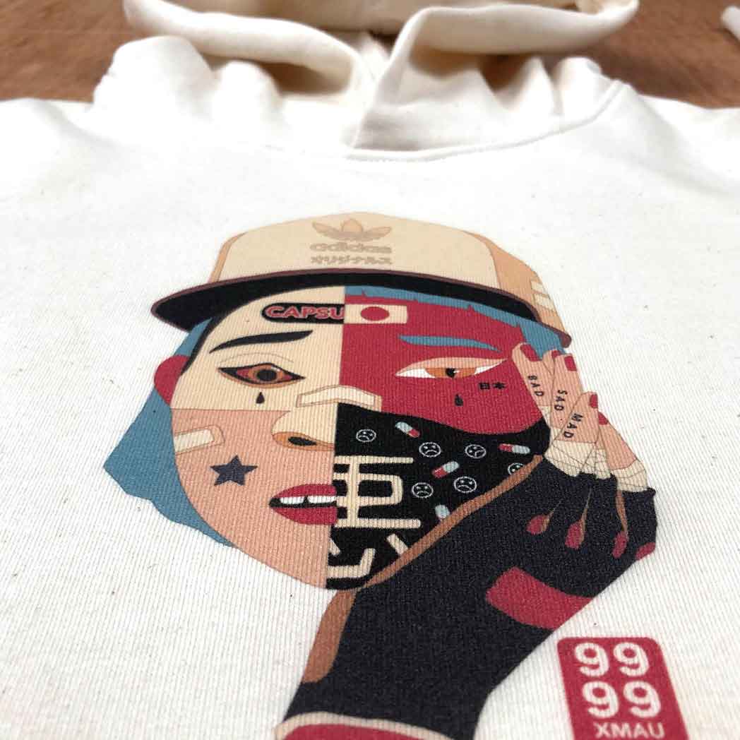 White hoodie with a colorful graphic design of a face wearing a cap and mask.
