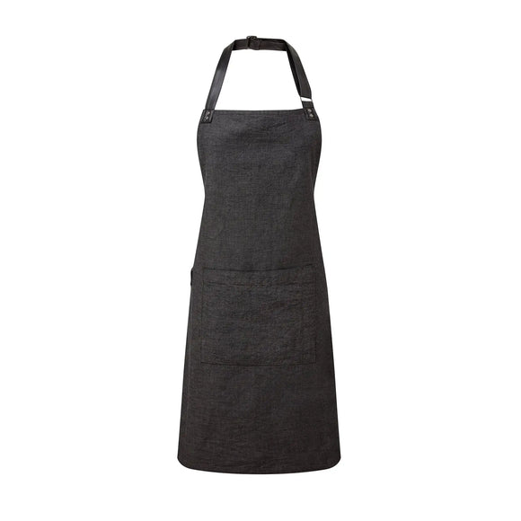 A black bib-apron with a leather-like adjustable strap at the neck and a pen pocket on the front. It is displayed against a white background. Premier Annex Oxford Bib Apron - PR144