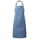 A blue denim bib apron with a center pocket, adjustable neck strap, displayed against a white background. Denim Bib Apron with Pocket - PR154