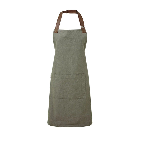 A moss green bib-apron with a pen pocket and brown straps, made of cotton fabric. It is displayed against a white background Premier Annex Oxford Bib Apron - PR144