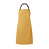 A mustard yellow bib-apron with a leather-like adjustable strap at the neck and a pen pocket on the front. It is displayed against a white background. Premier Annex Oxford Bib Apron - PR144