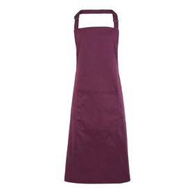 An aubergine purple bib apron with a neck strap and front pocket, displayed on a plain background. Colours Bib Apron with Pocket - PR154