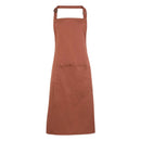 A chestnut brown bib apron with a neck strap and front pocket, displayed on a plain background. Colours Bib Apron with Pocket - PR154
