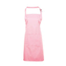 A pink bib apron with a neck strap and front pocket, displayed on a plain background. Colours Bib Apron with Pocket - PR154