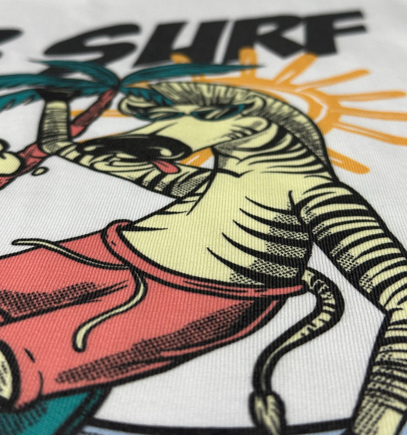 Close-up of a colourful zebra graphic printed directly onto a white T-shirt using DTG, showing fine detail and fabric texture.
