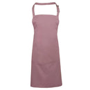 A rose pink bib apron with a neck strap and front pocket, displayed on a plain background. Colours Bib Apron with Pocket - PR154